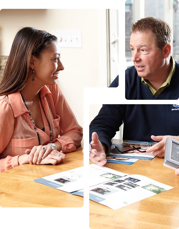 Man and woman discussing air conditioning options at a table with brochures, emphasizing Comfort Plus's HVAC services and professional installation benefits.