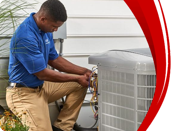 Technician in blue shirt performing maintenance on an outdoor HVAC unit, ensuring optimal performance and efficiency for heating and cooling systems.