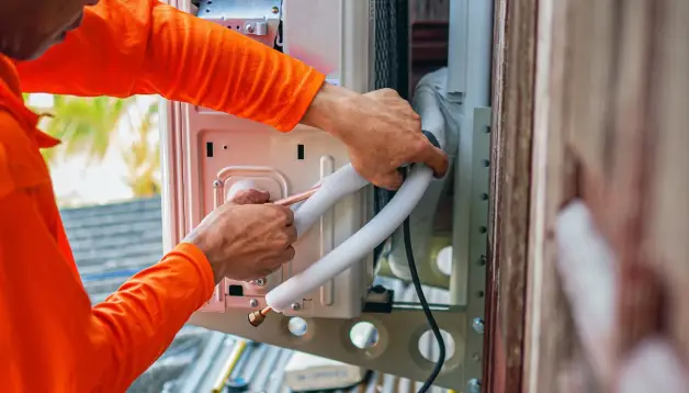 Technician installing heating system components, ensuring efficient operation and safety for residential or commercial properties.