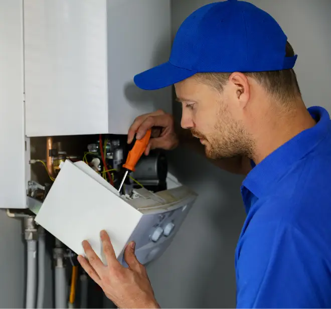 HVAC technician repairing a heating system, demonstrating expertise in furnace and boiler maintenance for efficient home heating in Clarkston.
