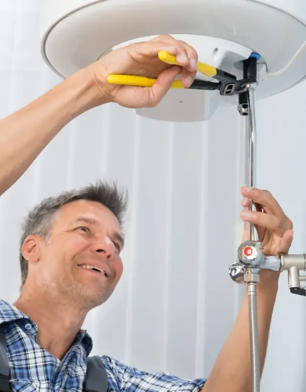 Technician installing a water heater, using tools for proper setup and ensuring compliance with safety standards.