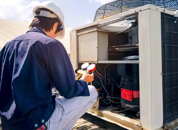Technician inspecting commercial heating system, ensuring proper installation and maintenance for reliable performance in Troy, MI.