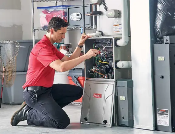 HVAC technician repairing a Bryant heating system, demonstrating professional service for efficient home heating solutions.