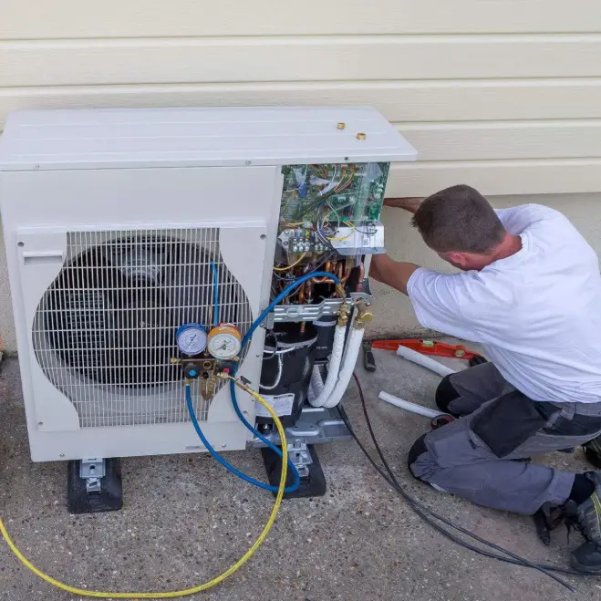 Technician servicing a commercial HVAC unit, focusing on maintenance and repair for efficient indoor air quality and comfort in Lake Orion.