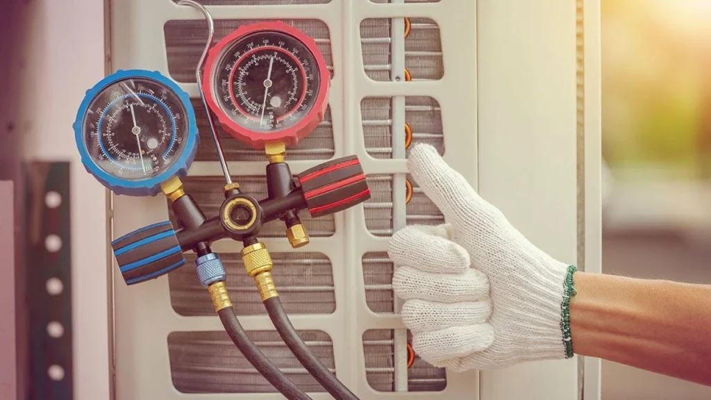 HVAC technician using pressure gauges on air conditioning unit, emphasizing professional service and maintenance for reliable heating and cooling in Beverly Hills.