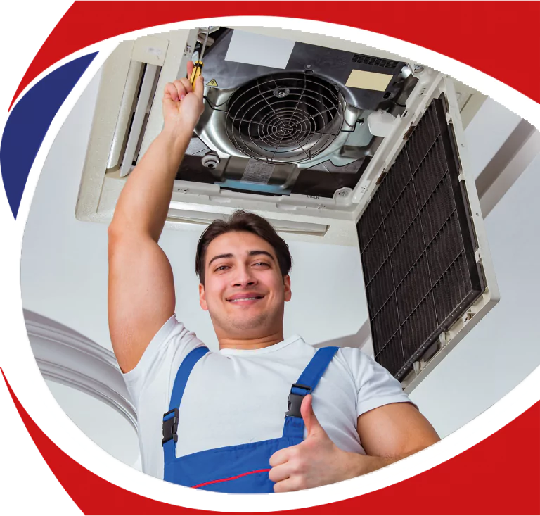HVAC technician smiling and thumbs up while performing maintenance on an air conditioning unit, emphasizing reliable service and expertise in heating and cooling solutions.
